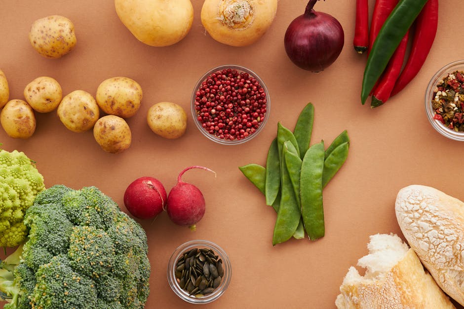 Top view of fresh ingredients including vegetables and bread, ideal for healthy cooking concepts.