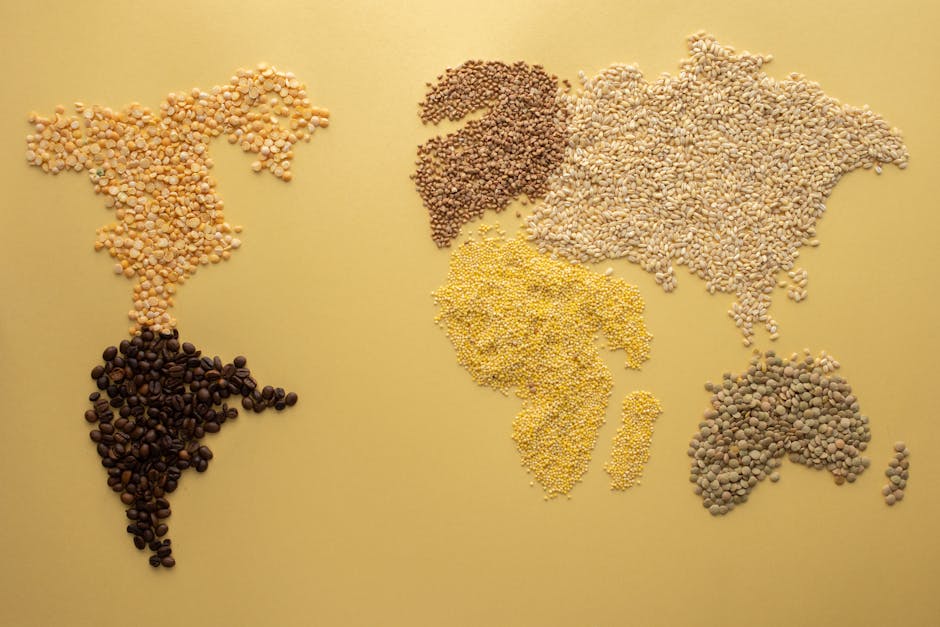 A world map creatively illustrated using diverse grains on a yellow background. Perfect for agricultural themes.